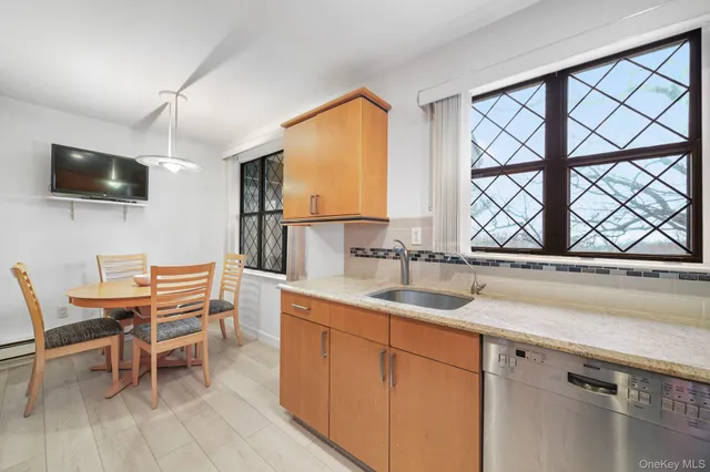 a kitchen with a sink a microwave a dining table and chairs