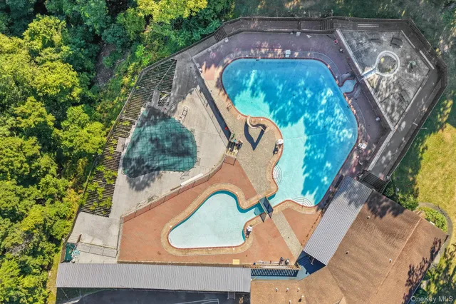 an aerial view of a house with garden space sitting space and swimming pool