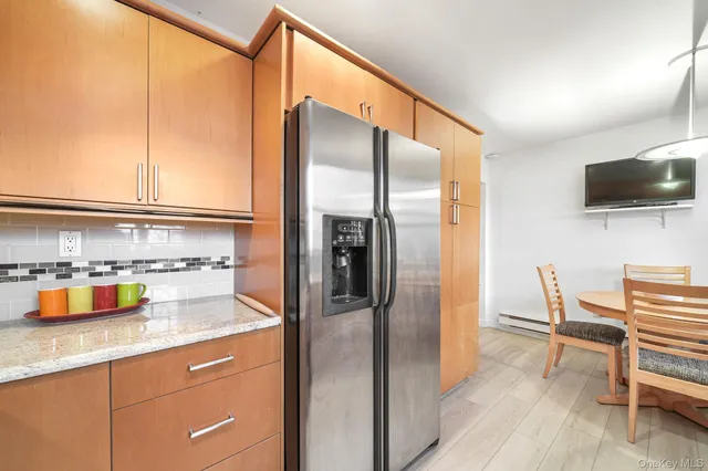 a kitchen with a refrigerator and microwave