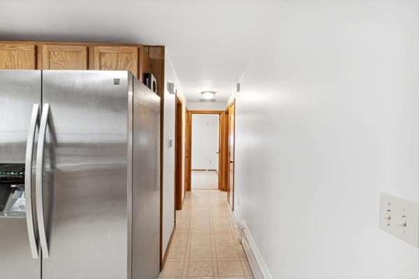 189 Brook Street Clinton, MA 01510 - Photo 12 of 29 a kitchen with a refrigerator and wooden floor