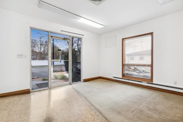 189 Brook Street Clinton, MA 01510 - Photo 20 of 29 an empty room with floor to ceiling windows and an outdoor view