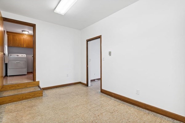 189 Brook Street Clinton, MA 01510 - Photo 23 of 29 an empty room with a mirror and a bathroom