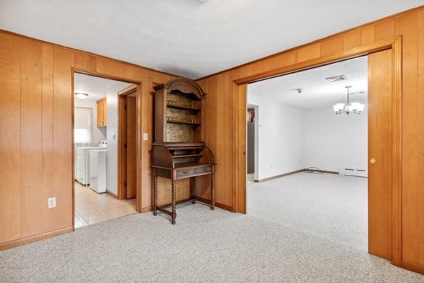 189 Brook Street Clinton, MA 01510 - Photo 5 of 29 an empty room with closet and wooden door