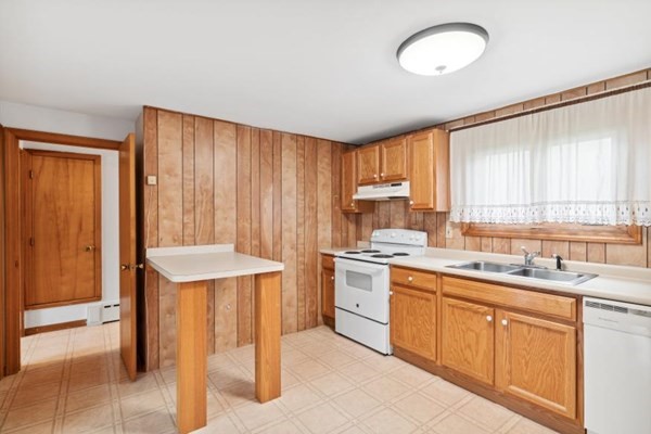 189 Brook Street Clinton, MA 01510 - Photo 10 of 29 a kitchen with a sink a stove cabinets and wooden floor