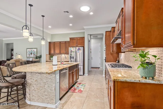 a kitchen with stainless steel appliances granite countertop sink stove and refrigerator