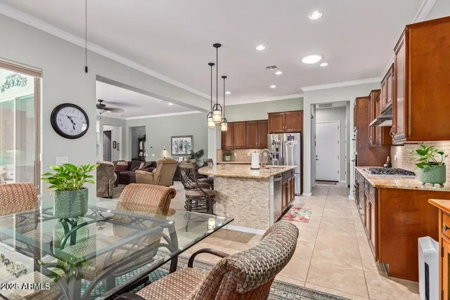 a living room with kitchen island furniture and a clock
