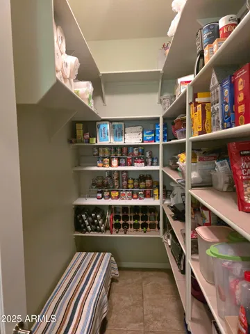 a room with lots of books and a large window