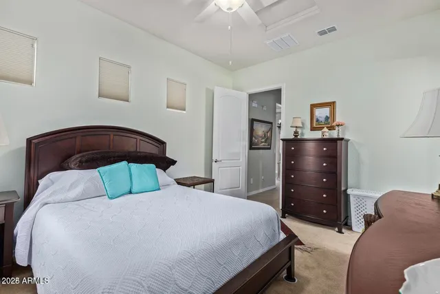 a bedroom with a bed and a dresser