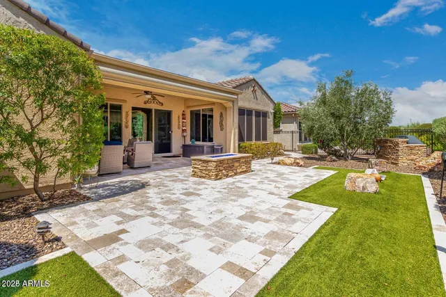 a view of a house with backyard and sitting area