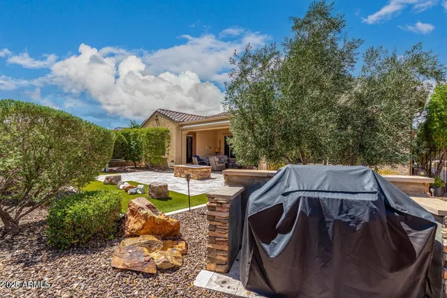 a view of house with swimming pool and furniture
