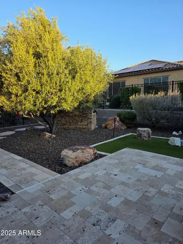 a view of a house with backyard and a tree