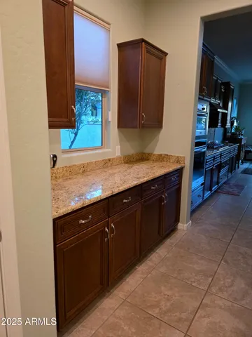 a kitchen with kitchen island granite countertop wooden cabinets and a sink