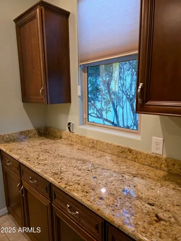 a view of a kitchen with wooden floor and a sink