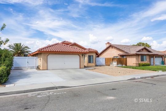 1012 Conejo Avenue Ridgecrest, CA 93555 - Photo 2 of 24 a front view of a house with a yard and garage