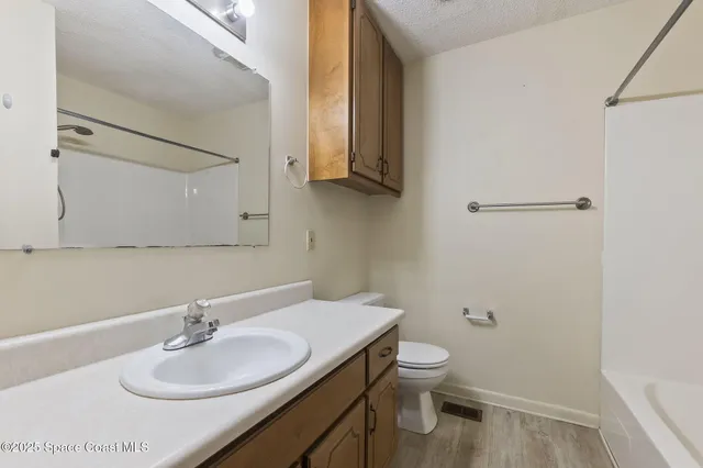 a bathroom with a sink toilet and mirror