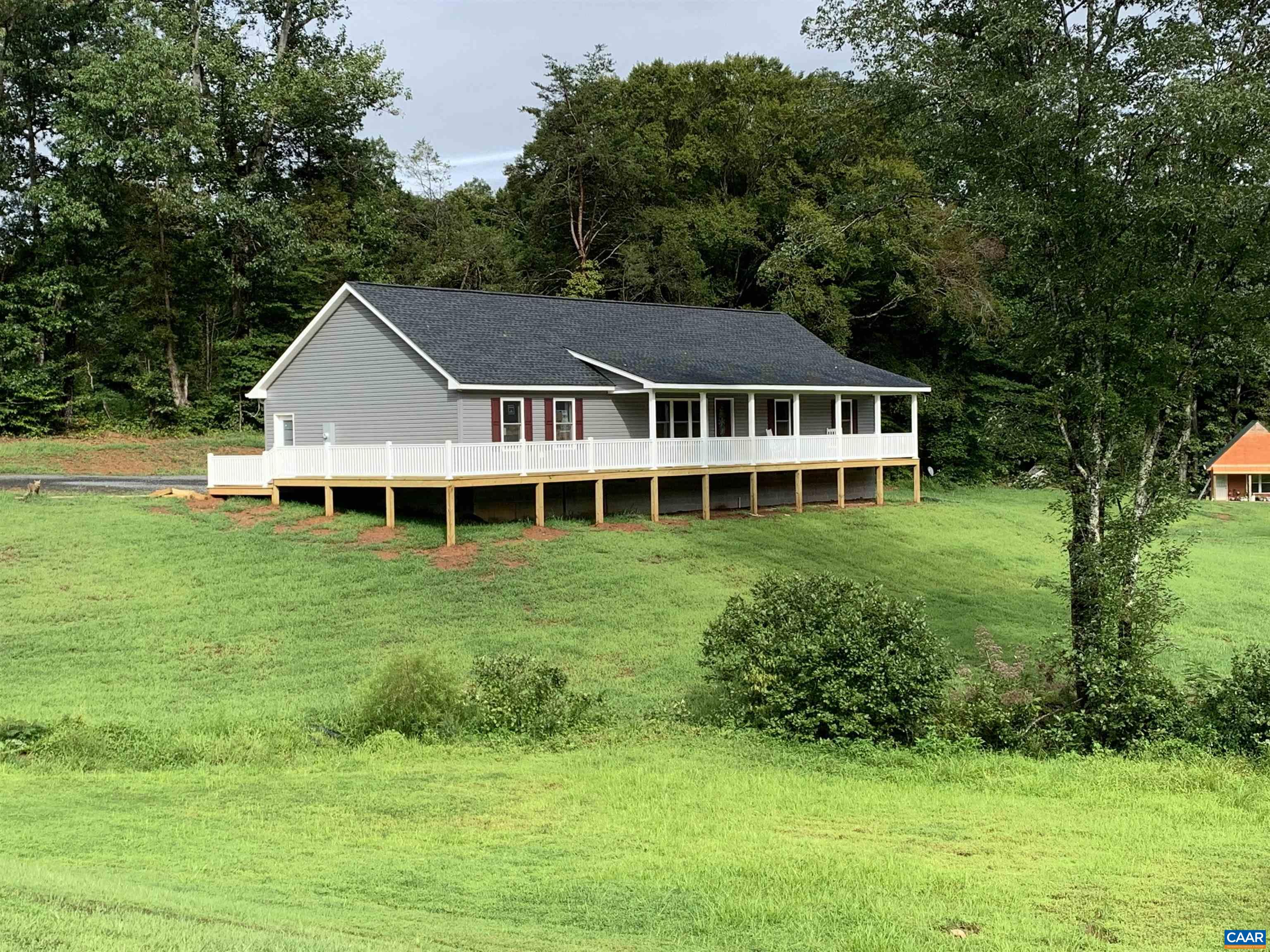 618 Chapel Road Ruckersville, VA 22968 - Photo 1 of 13 a front view of a house with a garden