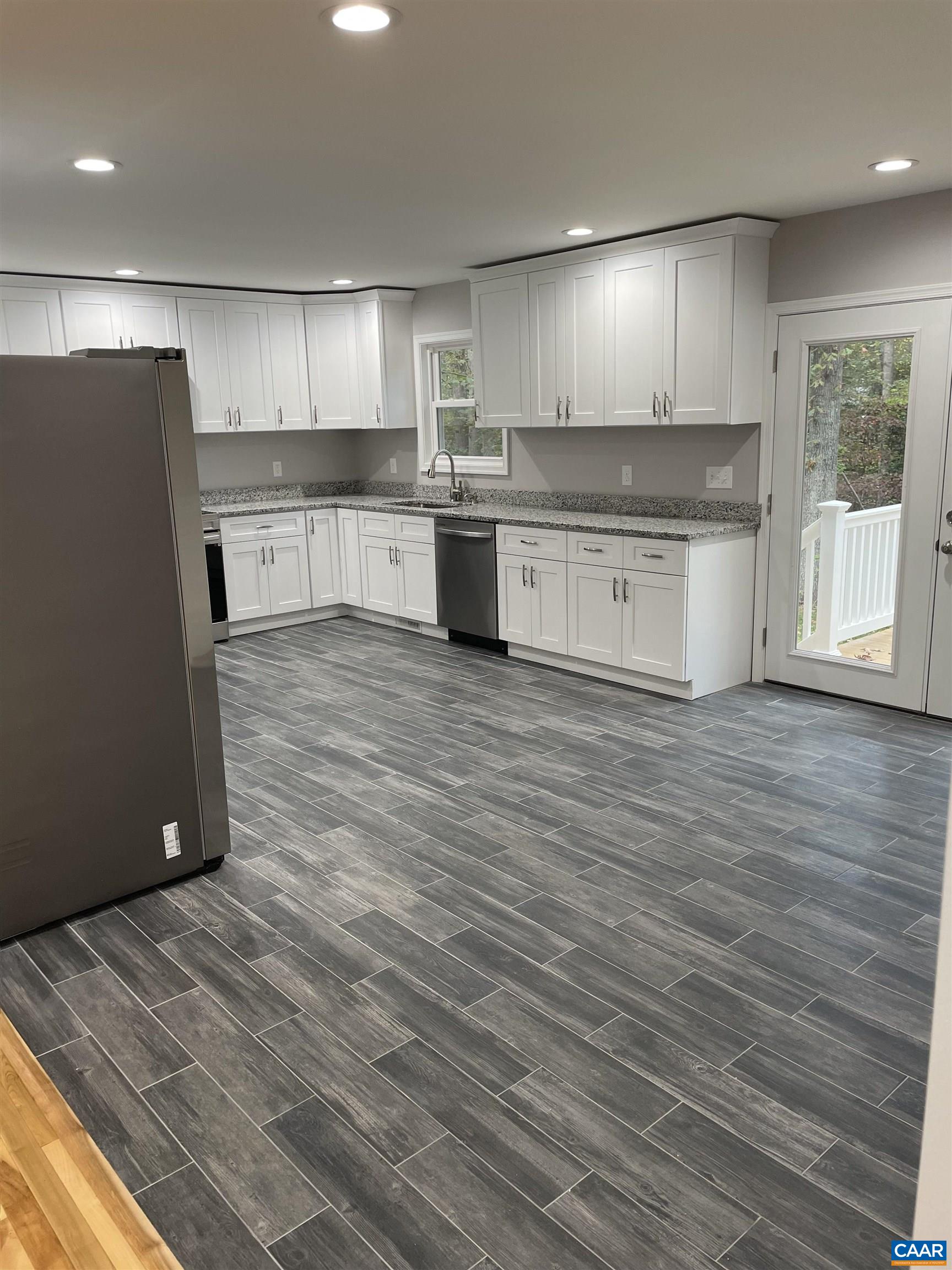 618 Chapel Road Ruckersville, VA 22968 - Photo 5 of 13 a kitchen with stainless steel appliances granite countertop a refrigerator sink and cabinets