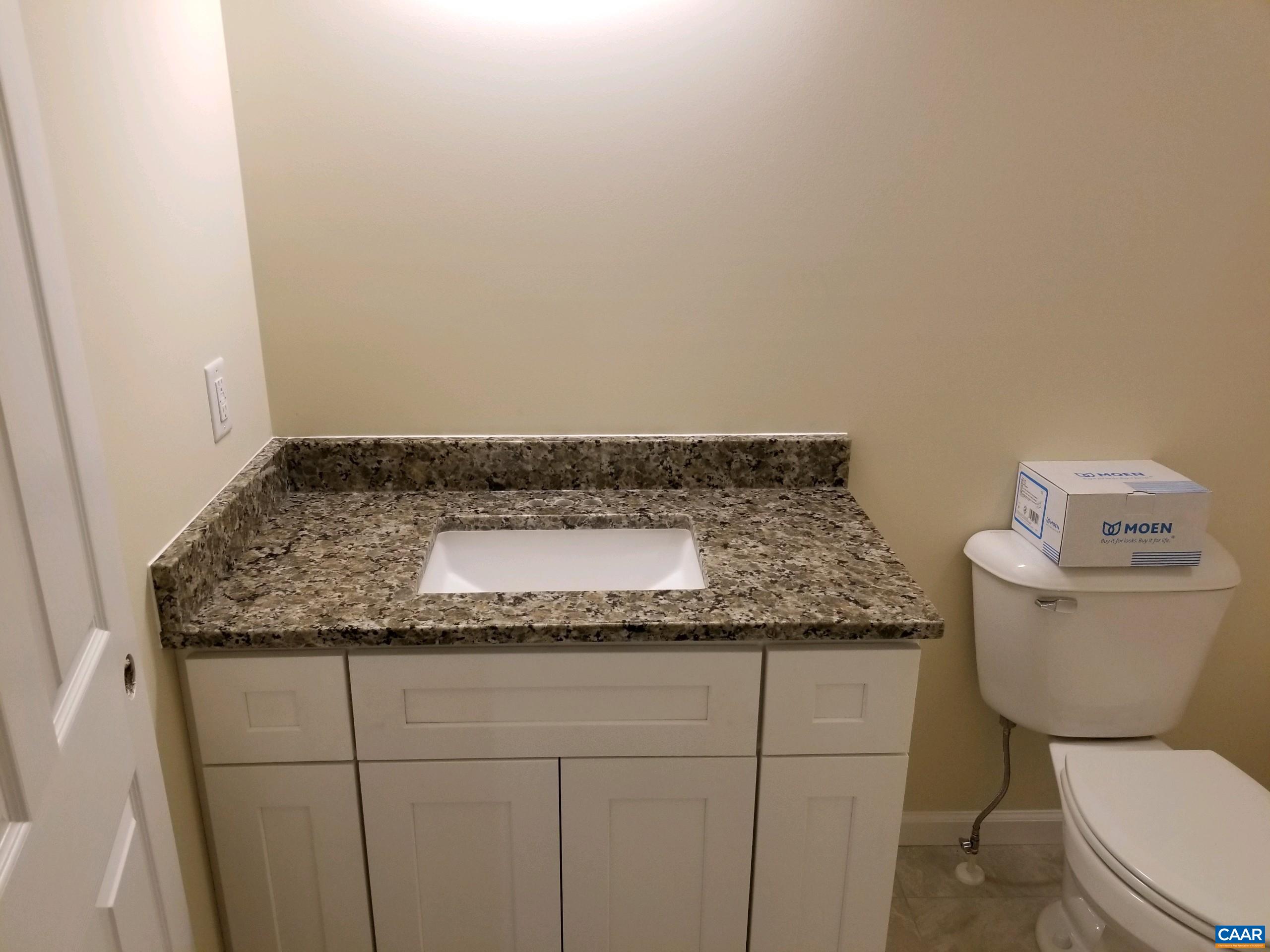 618 Chapel Road Ruckersville, VA 22968 - Photo 10 of 13 a bathroom with a granite countertop toilet and a sink