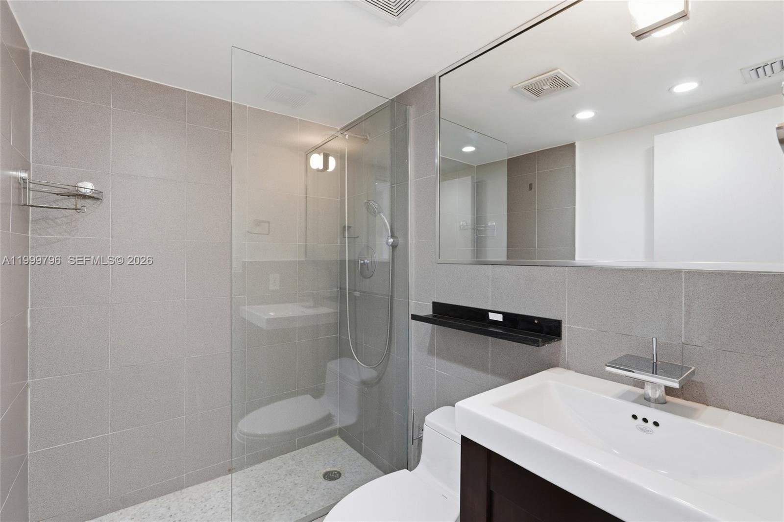 1627 Brickell Avenue, Unit 603 Miami, FL 33129 - Photo 11 of 29 a bathroom with a sink toilet and shower