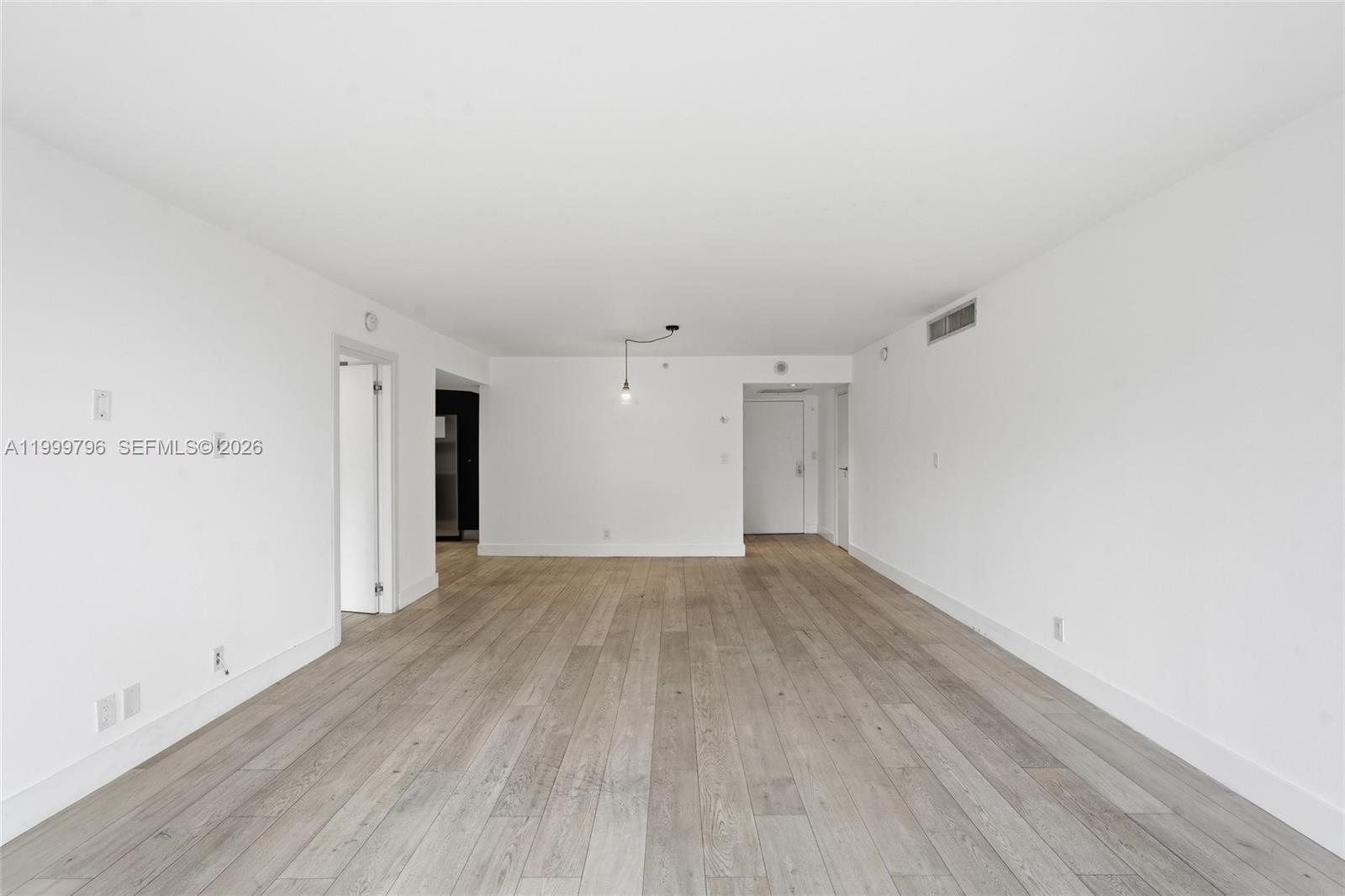 1627 Brickell Avenue, Unit 603 Miami, FL 33129 - Photo 17 of 29 a view of an empty room with wooden floor