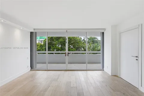 a view of a room with wooden floor and outdoor view