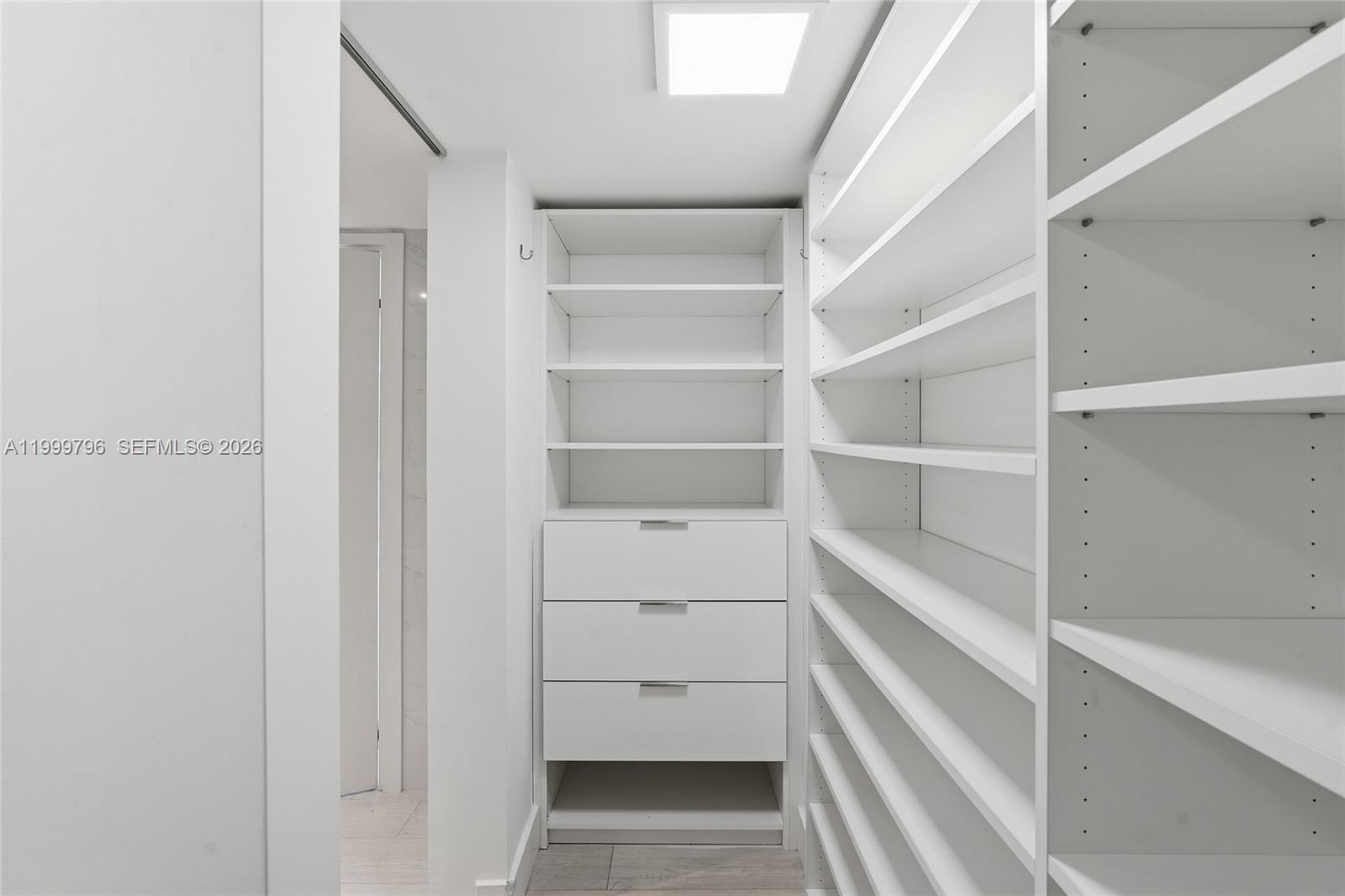 1627 Brickell Avenue, Unit 603 Miami, FL 33129 - Photo 26 of 29 a view of walk in closet with empty racks