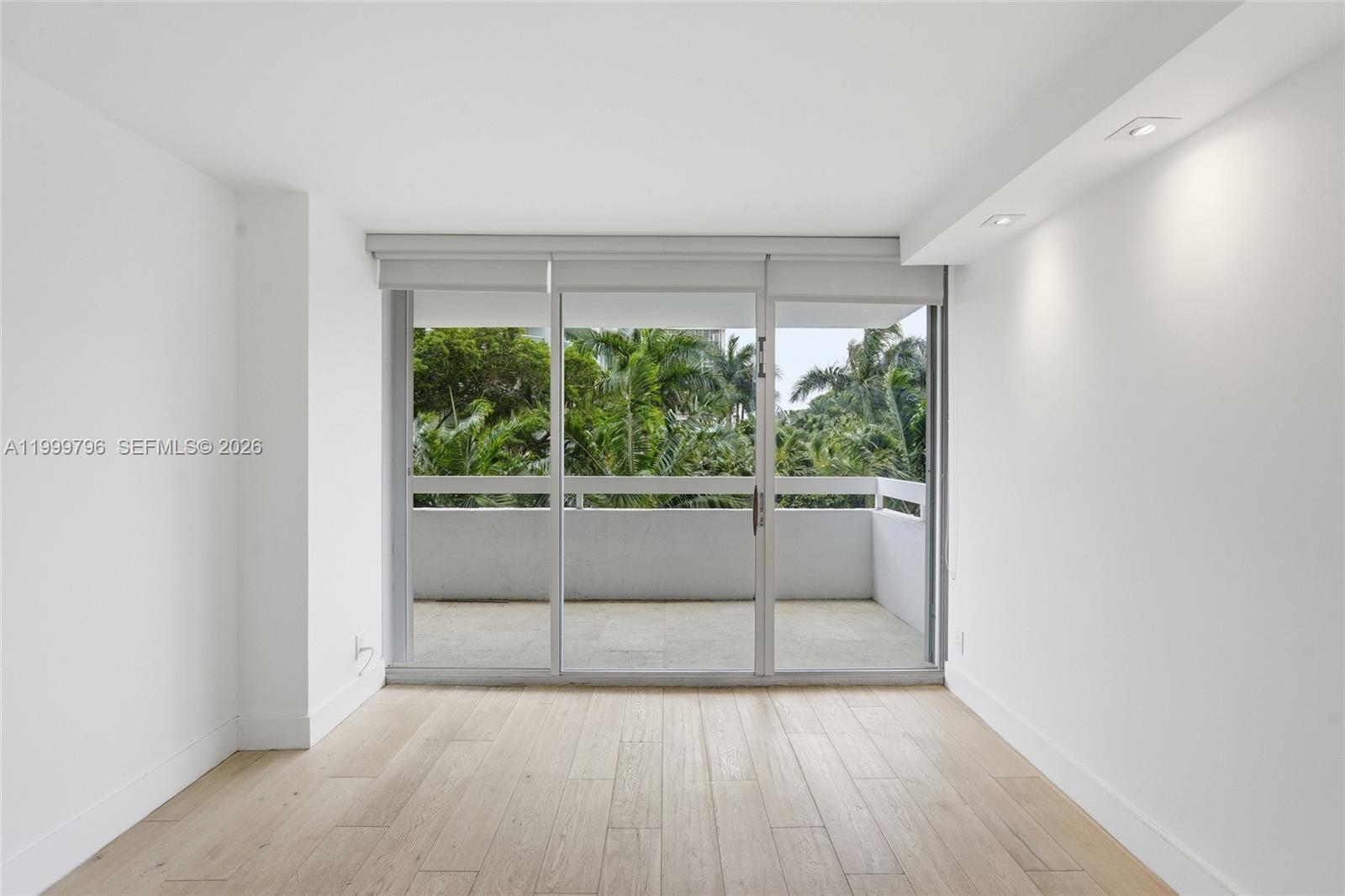 1627 Brickell Avenue, Unit 603 Miami, FL 33129 - Photo 8 of 29 a view of an empty room with wooden floor and a window