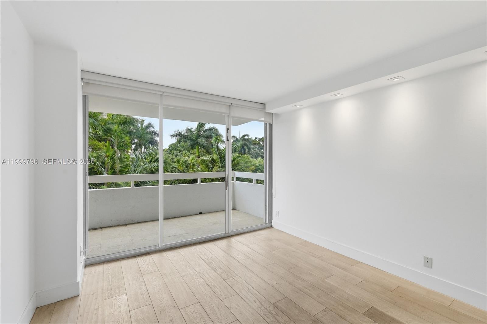 1627 Brickell Avenue, Unit 603 Miami, FL 33129 - Photo 9 of 29 a view of empty room with wooden floor and fan