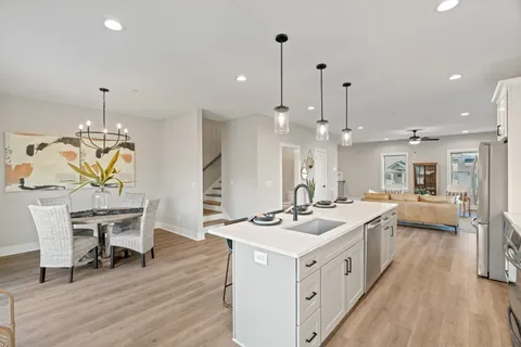 a kitchen with a table chairs and a white cabinets