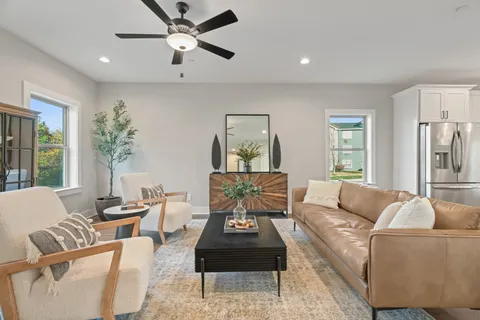 a living room with furniture and a chandelier