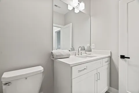 a white toilet sitting next to a bath tub and shower