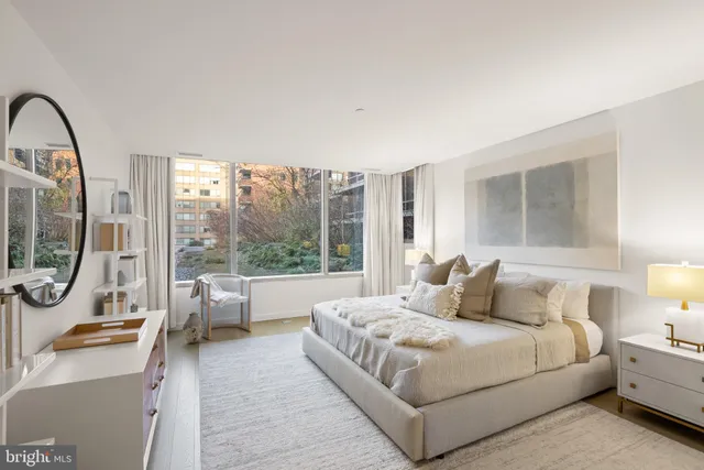 a bedroom with furniture and a mirror