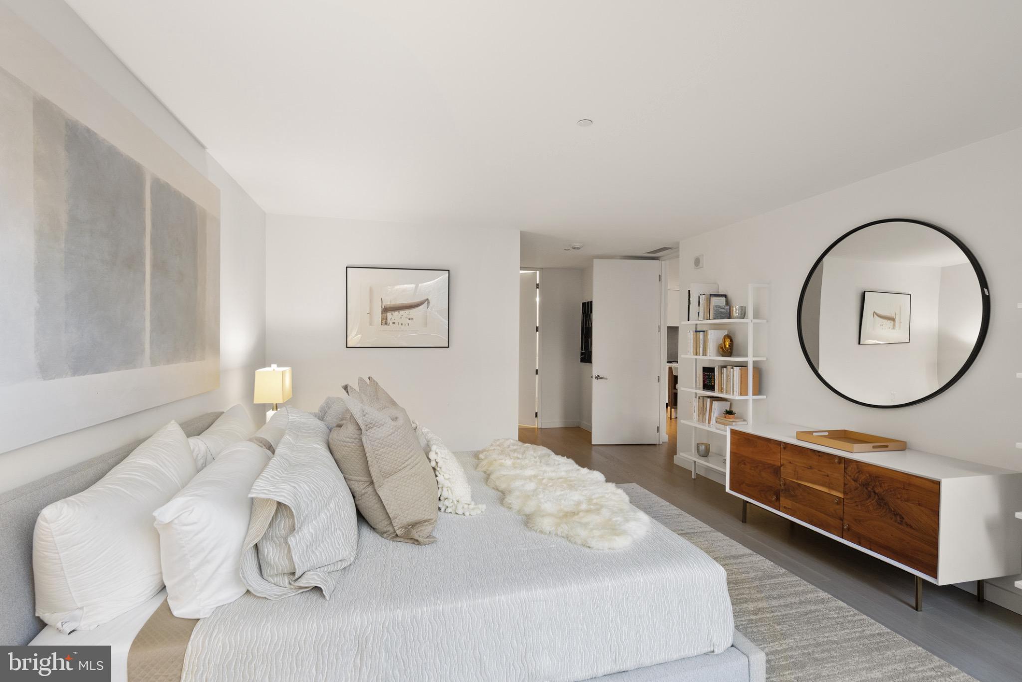 1111 24th Street Northwest, Unit 27 Washington, DC 20037 - Photo 22 of 57 a bedroom with furniture and a mirror