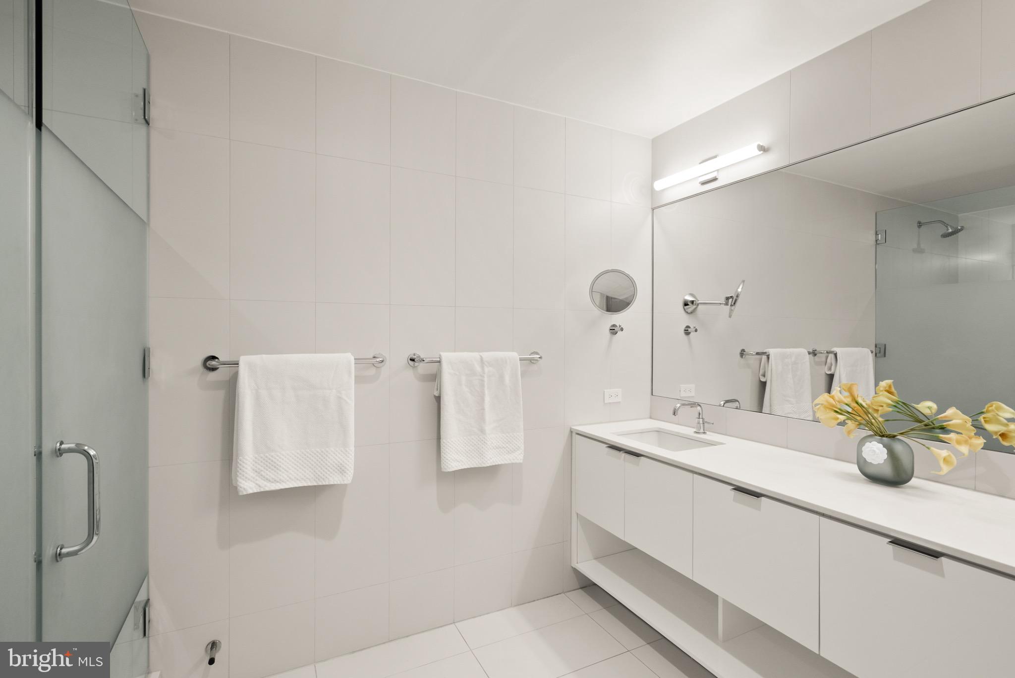 1111 24th Street Northwest, Unit 27 Washington, DC 20037 - Photo 24 of 57 a bathroom with a double vanity sink mirror and shower