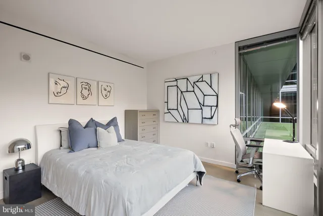 a bedroom with furniture and a window