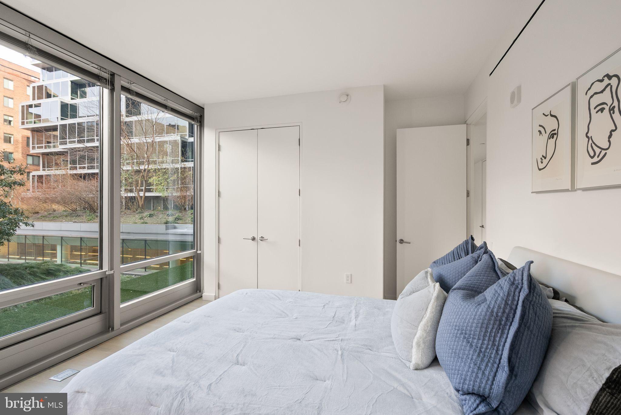 1111 24th Street Northwest, Unit 27 Washington, DC 20037 - Photo 27 of 57 a bed room with a bed and a large window