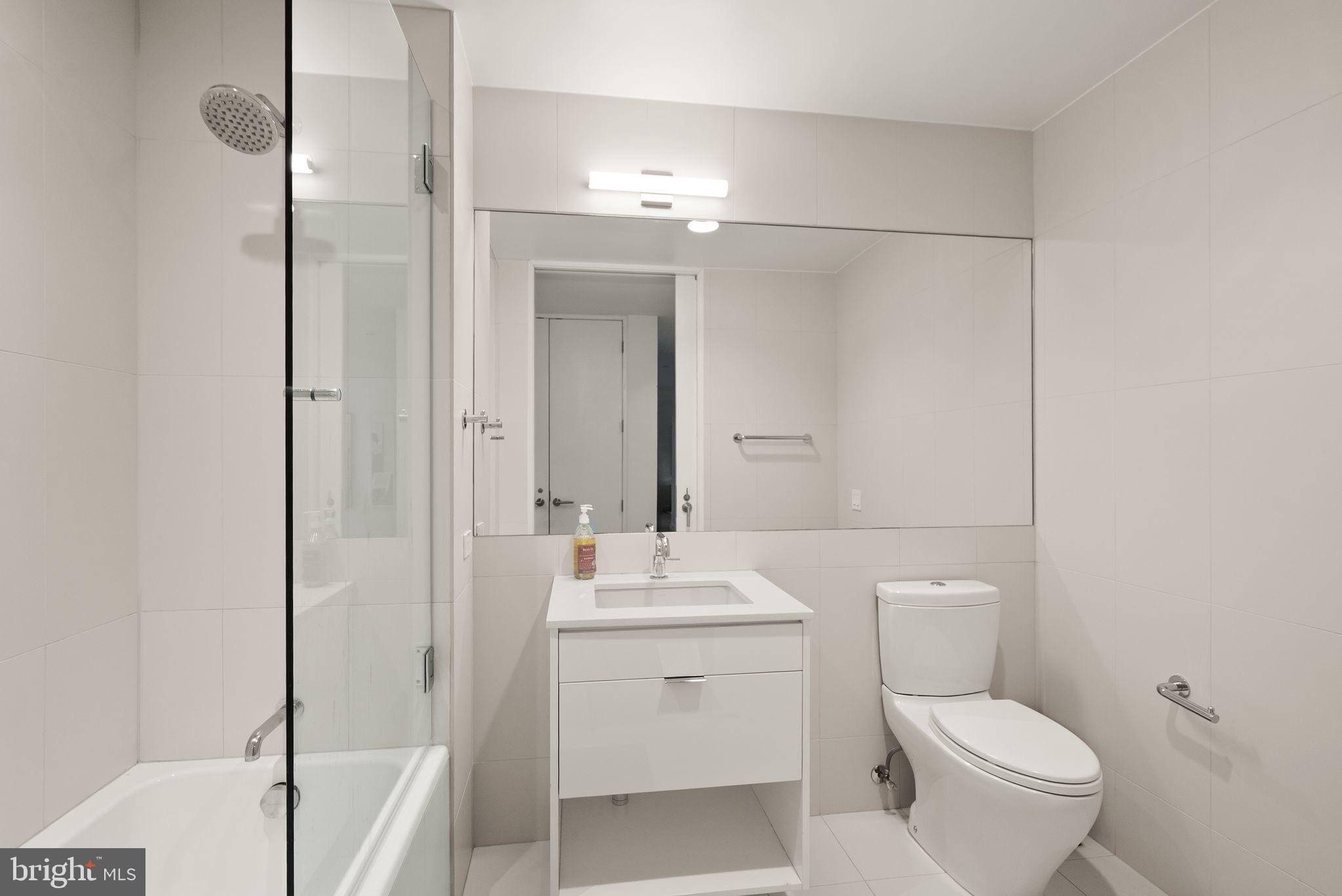 1111 24th Street Northwest, Unit 27 Washington, DC 20037 - Photo 29 of 57 a bathroom with a toilet sink and a mirror