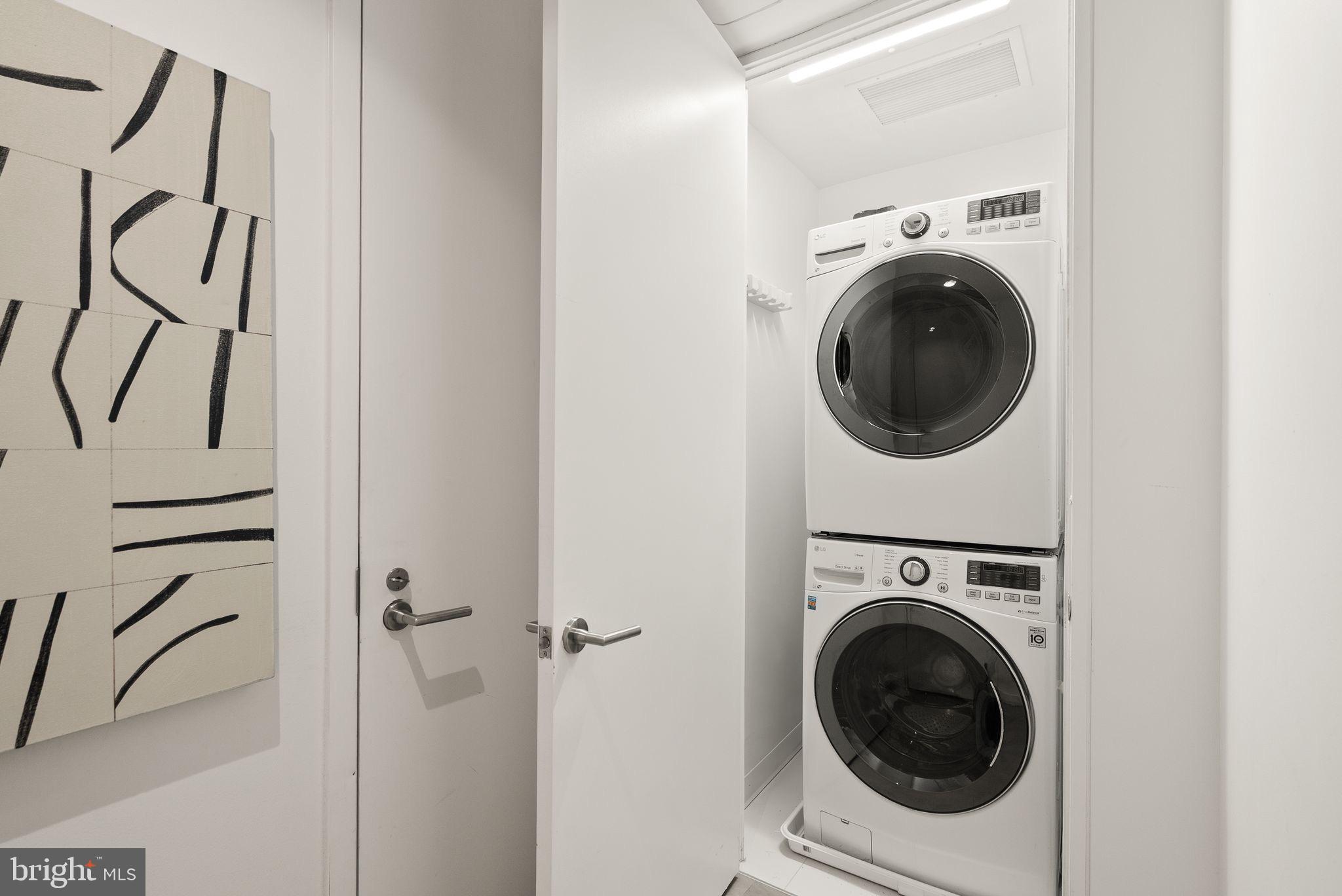 1111 24th Street Northwest, Unit 27 Washington, DC 20037 - Photo 31 of 57 a view of a hallway with washer and dryer