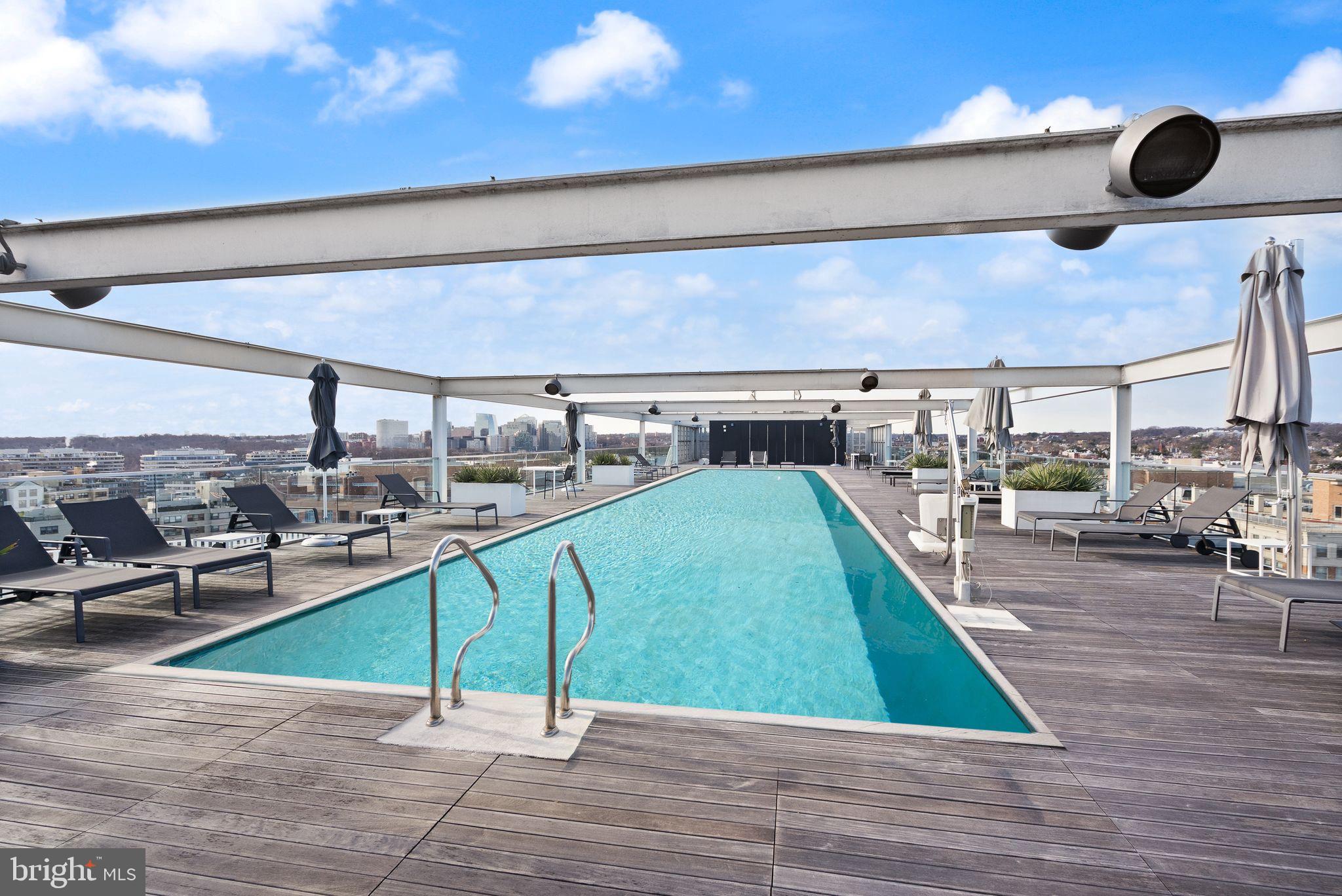 1111 24th Street Northwest, Unit 27 Washington, DC 20037 - Photo 44 of 57 a view of a swimming pool and lounge chair