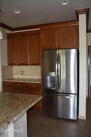 a kitchen with stainless steel appliances granite countertop a refrigerator and a sink