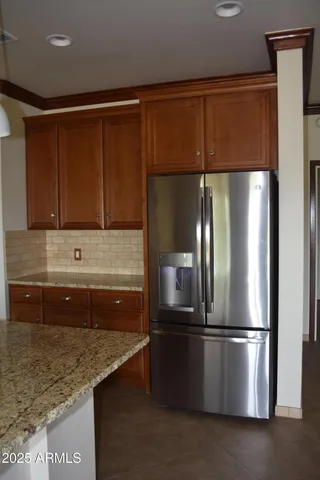 a kitchen with stainless steel appliances granite countertop a refrigerator and a sink