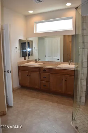 a large bathroom with a sink mirror and a bathtub