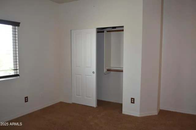 a bathroom with a granite countertop sink a mirror and a toilet