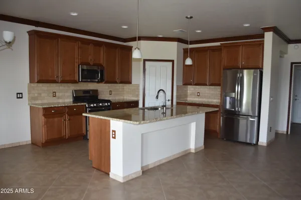 a kitchen with stainless steel appliances a refrigerator sink and microwave