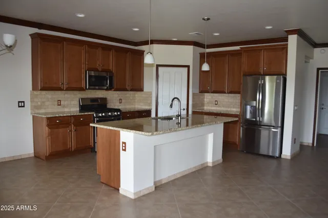 a kitchen with stainless steel appliances a refrigerator sink and microwave