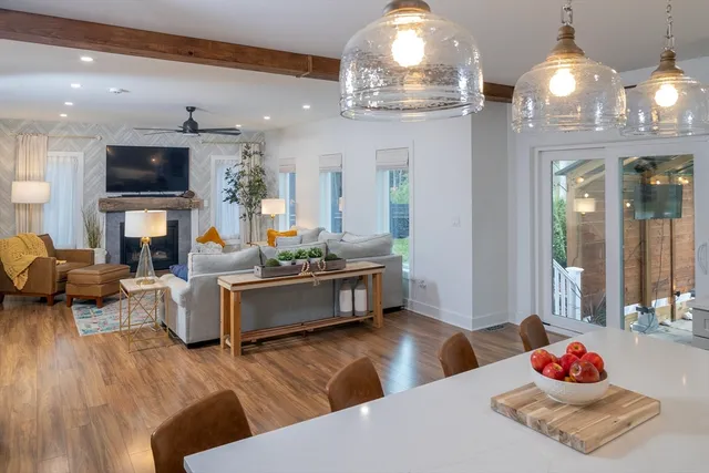 a living room with furniture and a chandelier