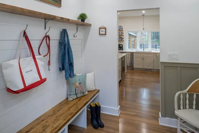 a view of a hallway with wooden floor and windows