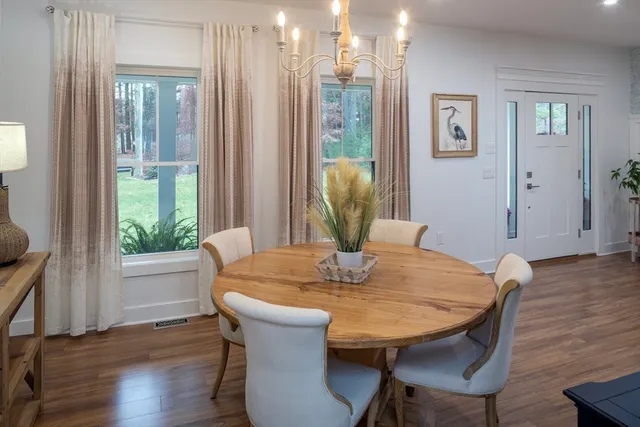 a view of a dining room with furniture window and wooden floor