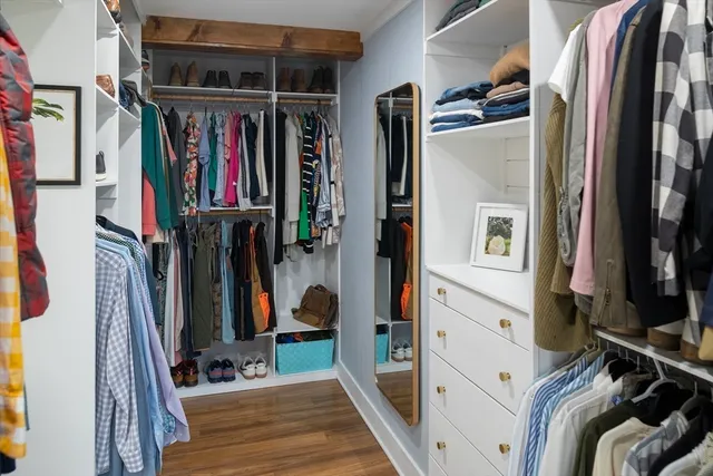 a view of walk in closet with clothes and shoes