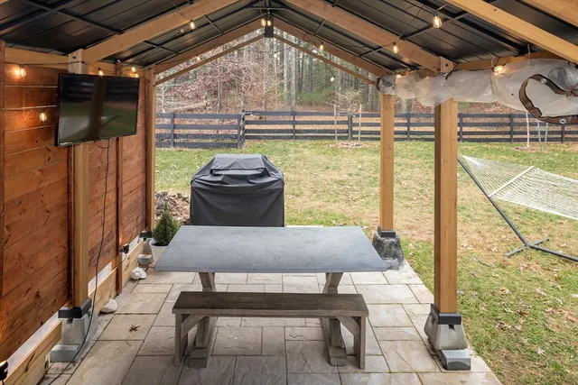 a front view of a house with yard outdoor seating and garage